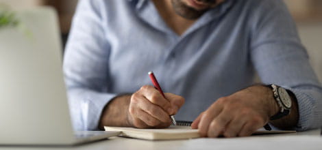 Man writing on a notepad